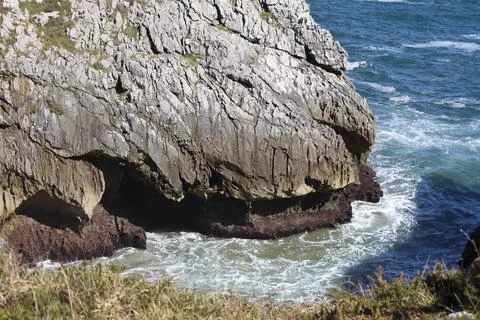 The Cliffs of Hell with beautiful rock formations and coves in Ribadesella .. Stock Photos