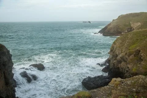 Cliffs High Up in Cornwall UK With Waves Breaking on Rocks Stock Photos