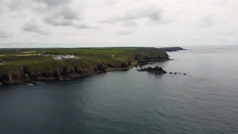 Cliffs off of Lands end with big waves and stunning scenery Cornwall UK Stock Footage 262657390