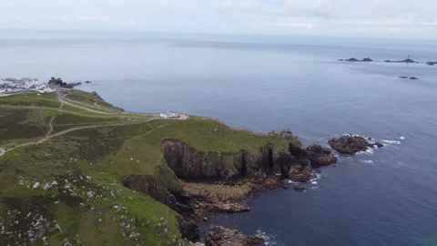 Cliffs off of Lands end with big waves and stunning scenery Cornwall UK Stock Footage 262658697