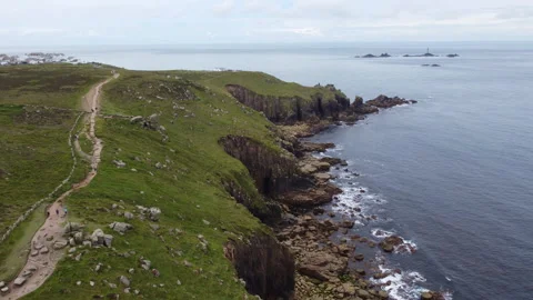 Cliffs off of Lands end with big waves and stunning scenery Cornwall UK Stock Footage 262674924