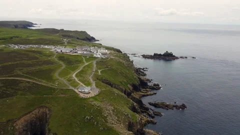 Cliffs off of Lands end with big waves and stunning scenery Cornwall UK Stock Footage 262675793