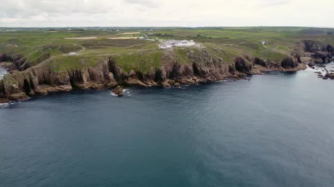 Cliffs off of Lands end with big waves and stunning scenery Cornwall UK Stock Footage 262675815