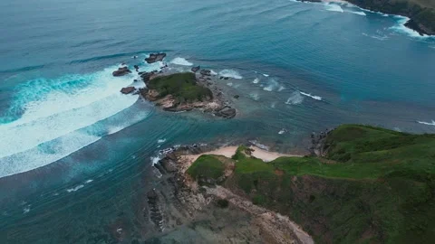 Cliffs Meet Ocean. Seaside Cliffs With Crashing Waves And Vibrant Coral Bands Stock Footage 331399739