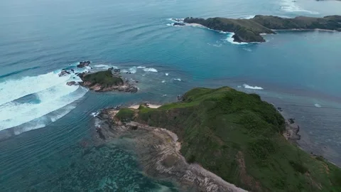 Cliffs Meet Ocean. Seaside Cliffs With Crashing Waves And Vibrant Coral Bands 스톡 동영상 333790649