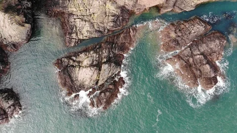 Cliffs meet the ocean seen from above Stock Footage 111827688