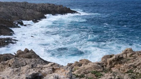 Cliffs of Menorca, Spain. Waves of blue sea hurl themselves on the rocks Stock Footage 162764662
