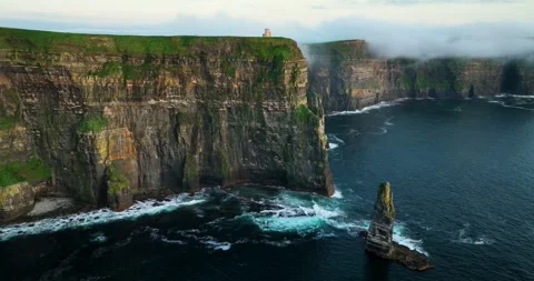 Cliffs of Moher with O'Brien's Tower and sea stack at sunrise, County Clare Stock Footage 339509310