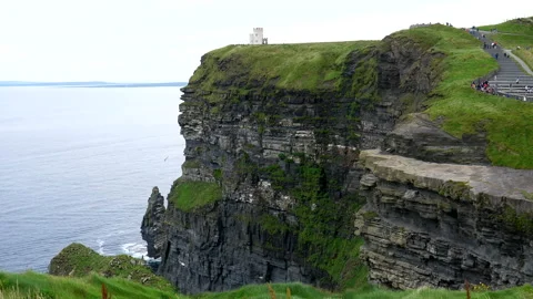 Cliffs of Moher. People on path to the tower Видео 136131898
