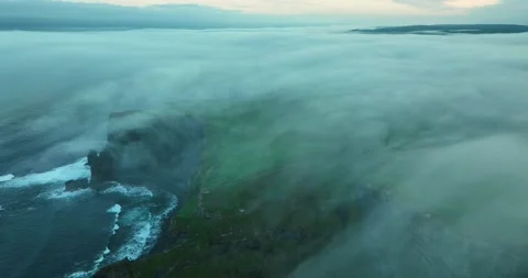 Cliffs of Moher shrouded in dense sea fog at sunrise, County Clare, Ireland Stock Footage 339508001
