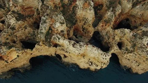 Cliffs in ocean near Ponte Piedade Lagos Portugal aerial view Stock Footage 64310036