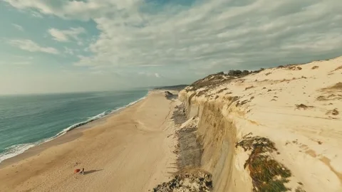 Cliffs overlook serene beach, waves softly crash Stock Footage 340226630