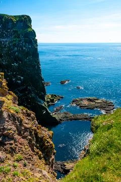 Cliffs overlooking the deep blue ocean Stock Photos