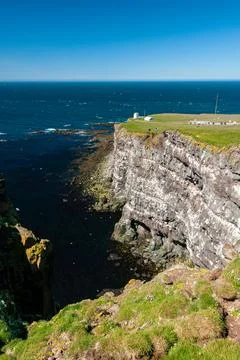 Cliffs overlooking the deep blue ocean Stock Photos