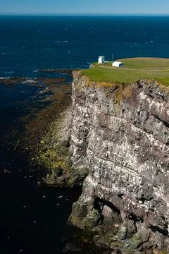 Cliffs overlooking the deep blue ocean Stock Photos