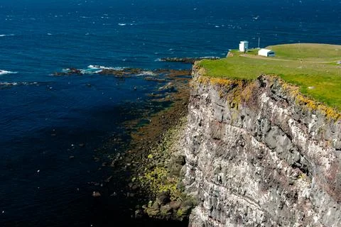 Cliffs overlooking the deep blue ocean Stock Photos