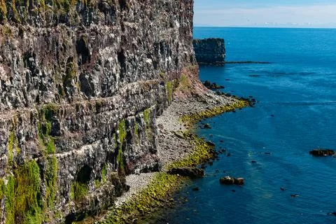 Cliffs overlooking the deep blue ocean Stock Photos