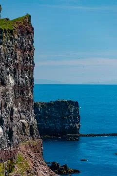 Cliffs overlooking the deep blue ocean Stock Photos