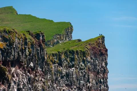 Cliffs overlooking the deep blue ocean Stock Photos