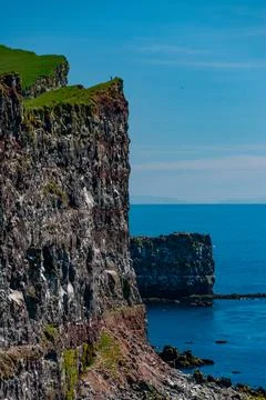 Cliffs overlooking the deep blue ocean Stock Photos