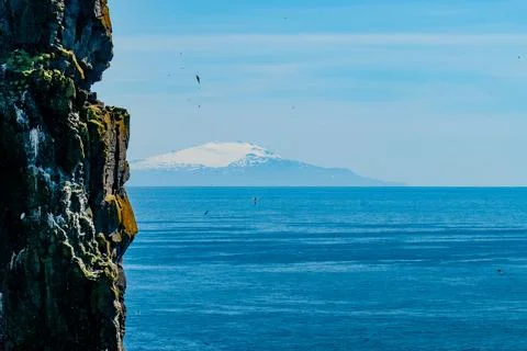 Cliffs overlooking the deep blue ocean Stock Photos