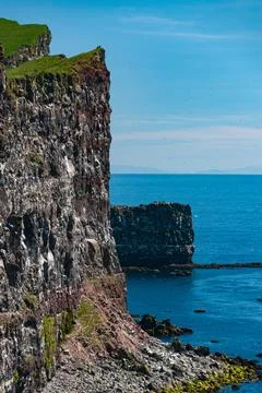 Cliffs overlooking the deep blue ocean Stock Photos