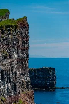 Cliffs overlooking the deep blue ocean Stock Photos