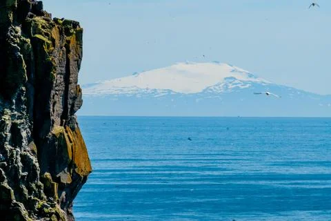 Cliffs overlooking the deep blue ocean Stock Photos