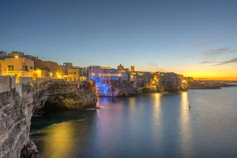The cliffs of Polignano a Mare after sunset Stock Photos