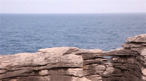 Cliffs of rock with the ocean behind Stock Footage 55798731