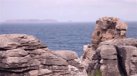 Cliffs of rocks with an island and the ocean behind Stock-Footage 55798764