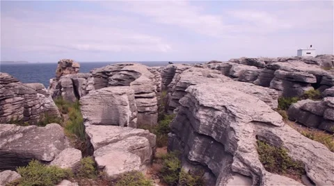 Cliffs of rocks with an island and the ocean behind Stock Footage 55798947