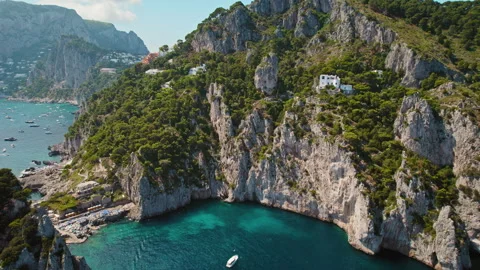 Cliffs on secluded cove with famous Da Luigi ai Faraglioni beach on Capri, italy Stock Footage 265190338
