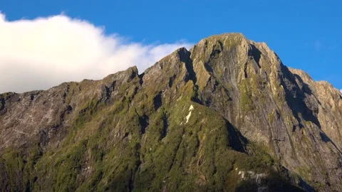 Cliffs in the sun rays and blue sky in New Zealand Milford Sound 스톡 동영상 132062791