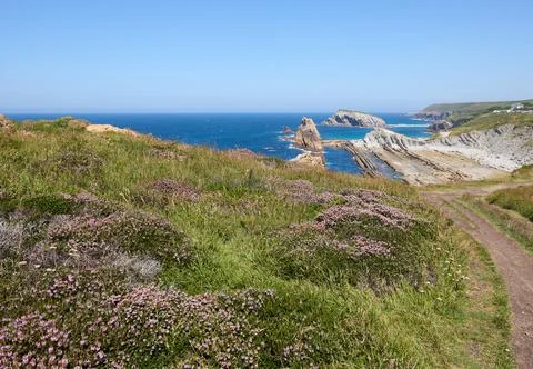 Cliffs surrounded by clear waters and blue skies Stock Photos