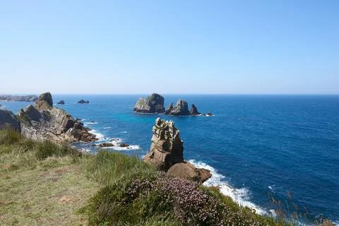 Cliffs surrounded by clear waters and blue skies Stock Photos