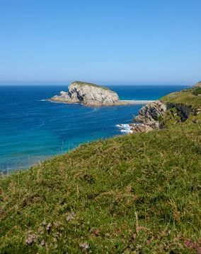 Cliffs surrounded by clear waters and blue skies Stock Photos
