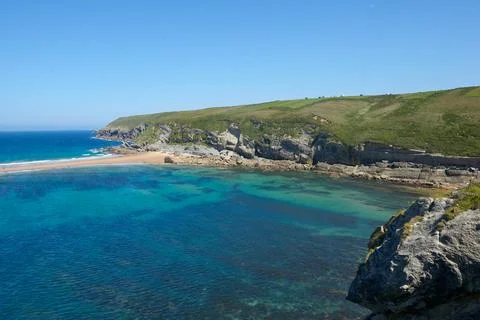 Cliffs surrounded by clear waters and blue skies Stock Photos