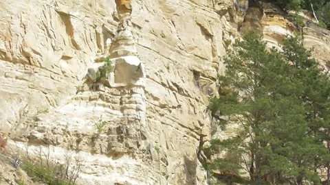 Cliffs with a tree and stone finger Stock Footage 335587246