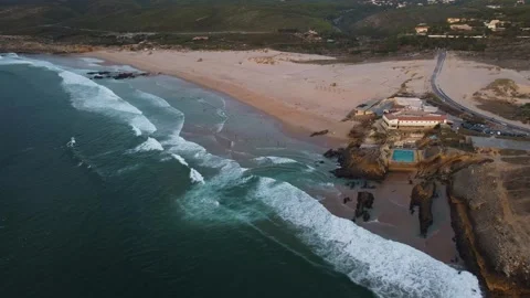 Cliffside aquatic haven, turquoise waves crashing ashore, scenic coastal resort Stock Footage 325526643