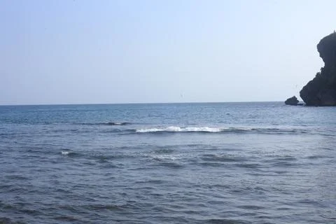 Cliffside Beach with Calm Waves Stock Photos