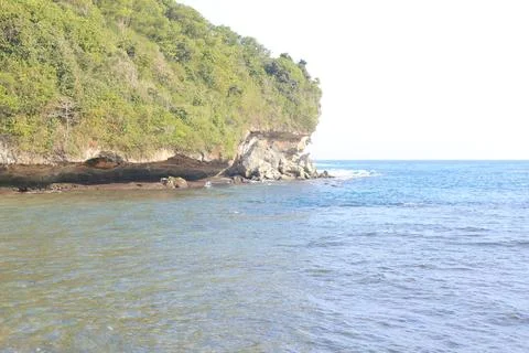 Cliffside Beach with Calm Waves Stock Photos