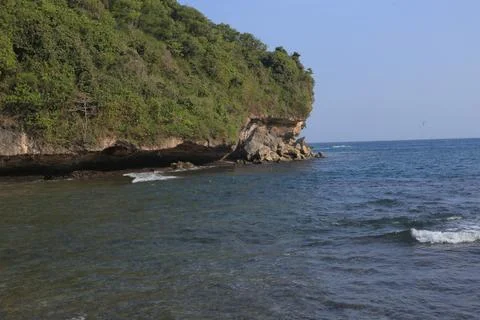 Cliffside Beach with Calm Waves Stock Photos