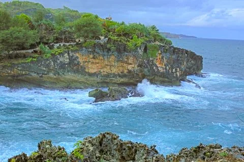 Cliffside Beach with Calm Waves Stock Photos