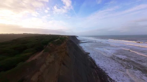 Cliffside beach scene captured from above at golden hour Stock Footage 344676665