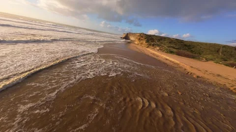 Cliffside coastal scene with powerful waves and winding road Video stock 344550942