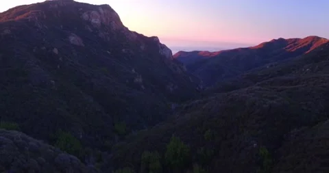 Cliffside landscape view of forest mountain sunset Stock Footage 136336934