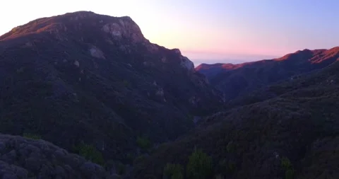 Cliffside landscape view of forest mountain sunset Stock Footage 136336969