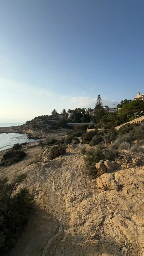 Cliffside panoramic view of a rugged coastline in Alicante, Spain Stock Footage 294821336