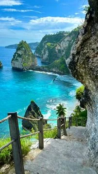 Cliffside-pathway-overlooking-tropical-ocean-and-rocky-islands Stock Photos